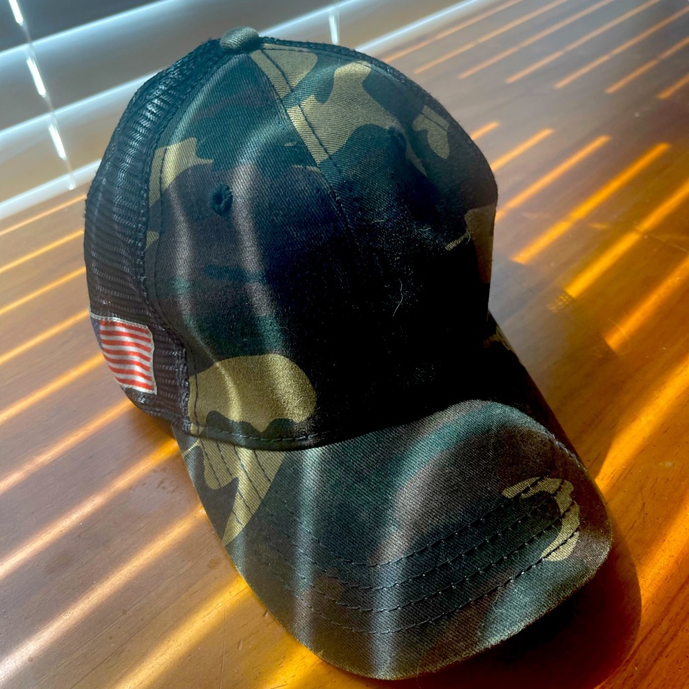 A Camo adjustable hat with American flag